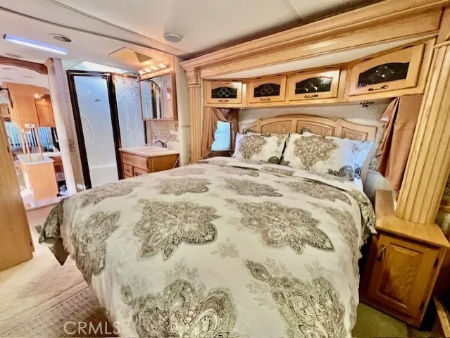 a bedroom with a large bed and a mirror