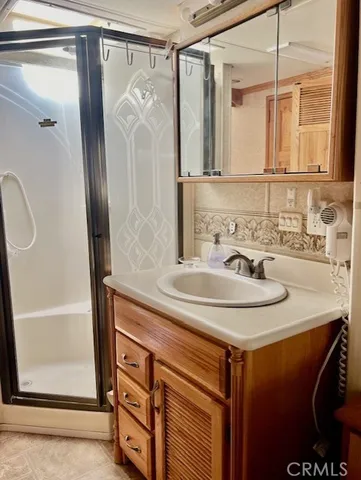 a bathroom with a sink a vanity and a mirror
