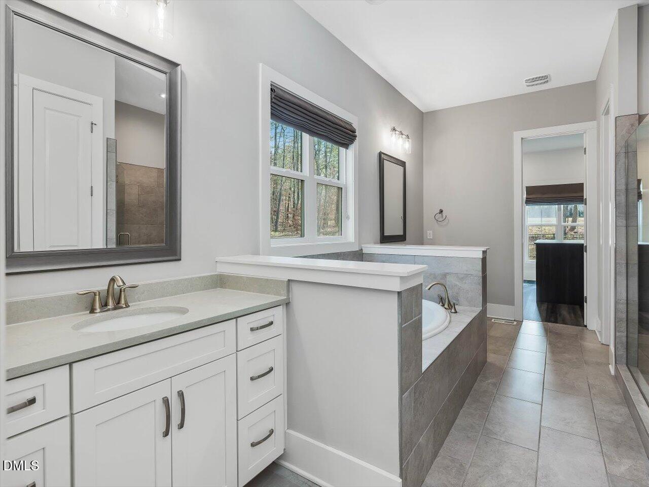 5212 Purnell Road Wake Forest, NC 27587 - Photo 16 of 36 a bathroom with a sink and a mirror