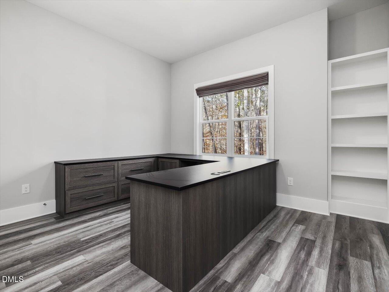 5212 Purnell Road Wake Forest, NC 27587 - Photo 20 of 36 a kitchen with granite countertop a sink a stove cabinets and wooden floor