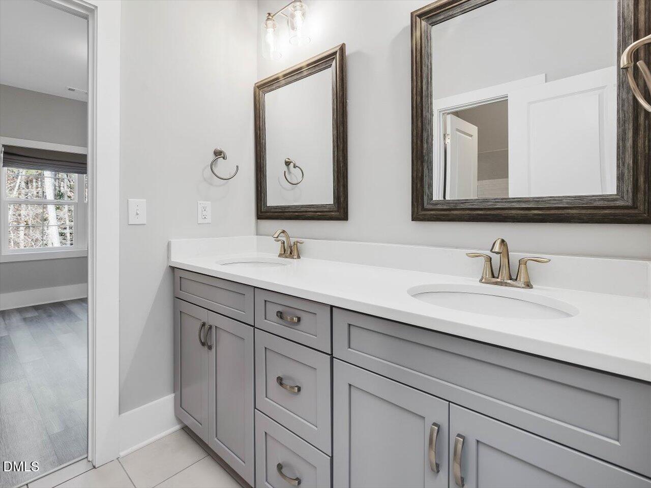 5212 Purnell Road Wake Forest, NC 27587 - Photo 27 of 36 a bathroom with double sink and a mirror