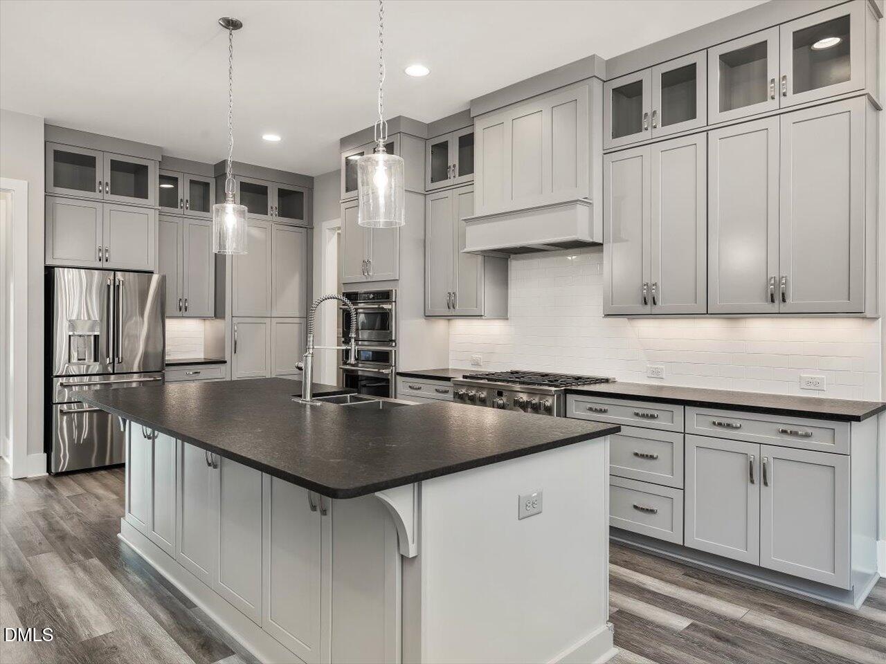 5212 Purnell Road Wake Forest, NC 27587 - Photo 3 of 36 a kitchen with stainless steel appliances granite countertop a sink stove and refrigerator