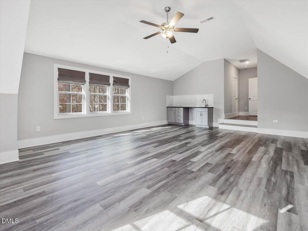 5212 Purnell Road Wake Forest, NC 27587 - Photo 30 of 36 a view of an empty room with a window and wooden floor
