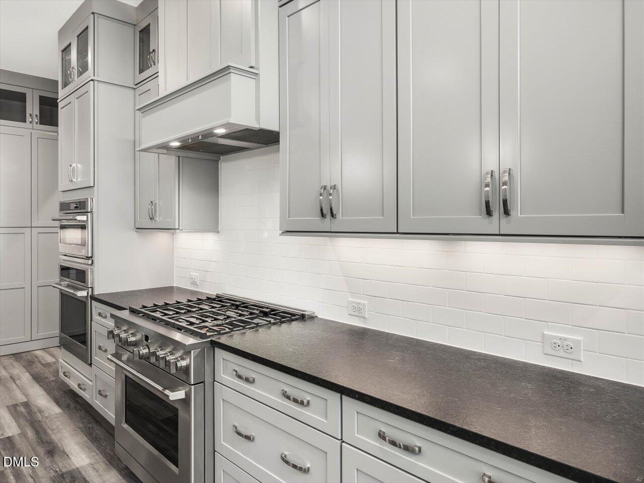 5212 Purnell Road Wake Forest, NC 27587 - Photo 7 of 36 a kitchen with stainless steel appliances granite countertop white cabinets and a stove