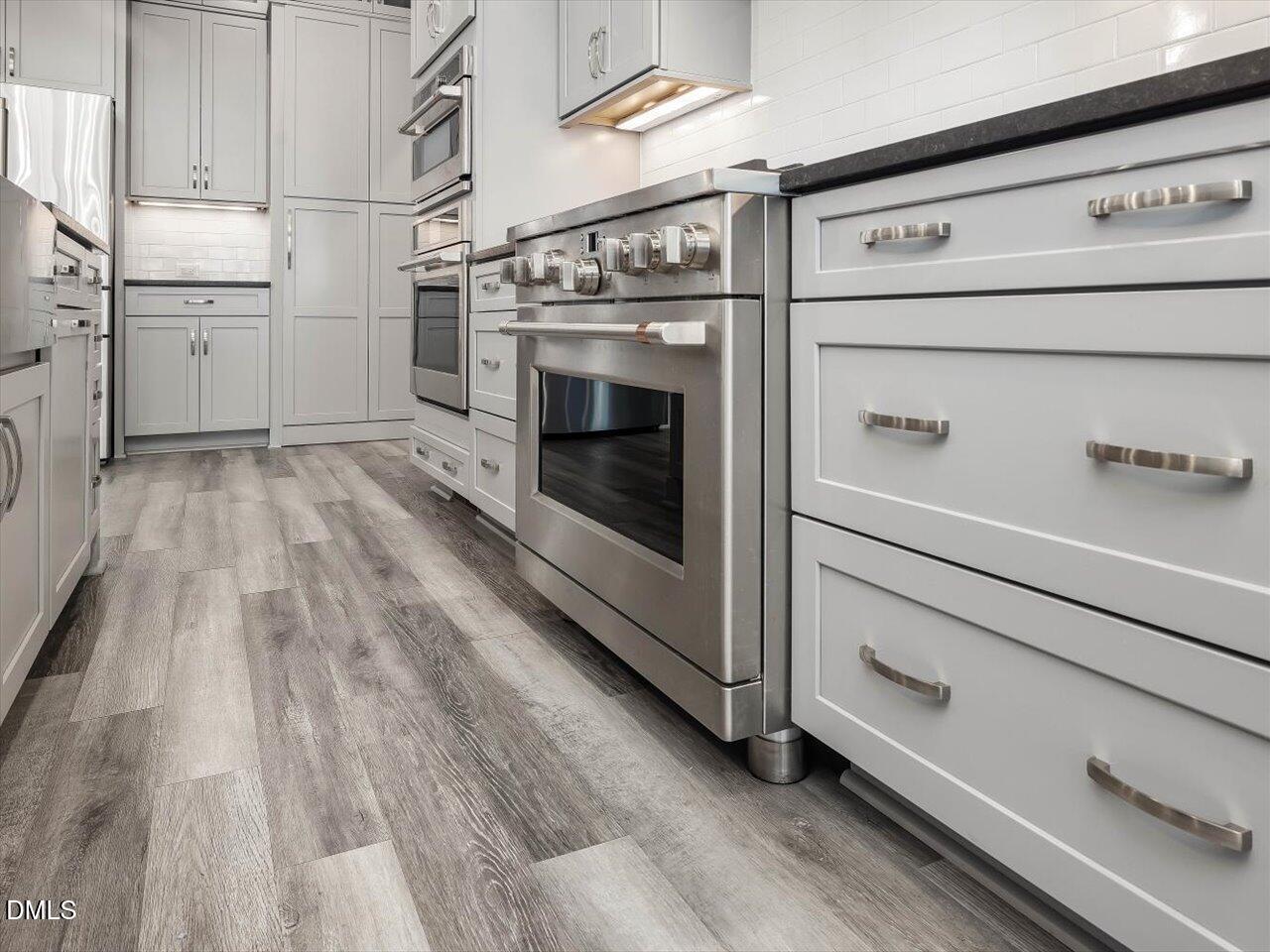 5212 Purnell Road Wake Forest, NC 27587 - Photo 8 of 36 a kitchen with cabinets and wooden floor