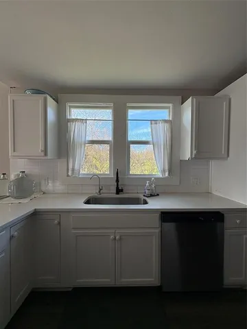 a kitchen with a sink stove and cabinets