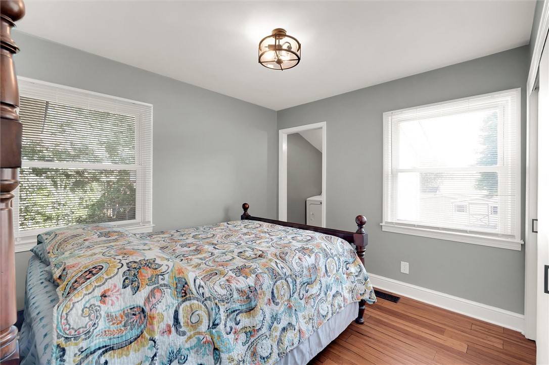 503 Stone Drive Anderson, SC 29625 - Photo 18 of 25 This inviting bedroom features rich hardwood flooring and abundant natural light through multiple windows.