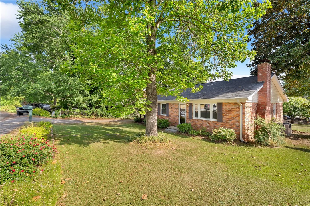 503 Stone Drive Anderson, SC 29625 - Photo 4 of 25 This charming residence showcases a classic brick exterior and a lush, expansive front yard.