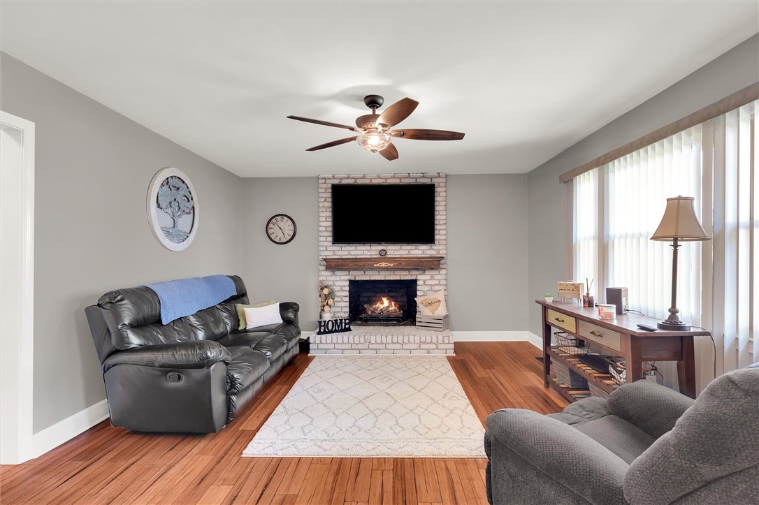 503 Stone Drive Anderson, SC 29625 - Photo 6 of 25 This inviting living space features warm hardwood floors and a cozy fireplace, perfect for relaxing evenings.