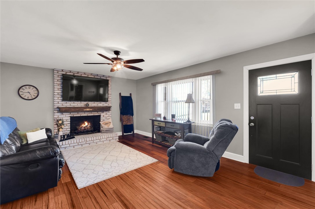 503 Stone Drive Anderson, SC 29625 - Photo 7 of 25 This inviting living space features warm hardwood floors and a cozy fireplace, perfect for relaxation.