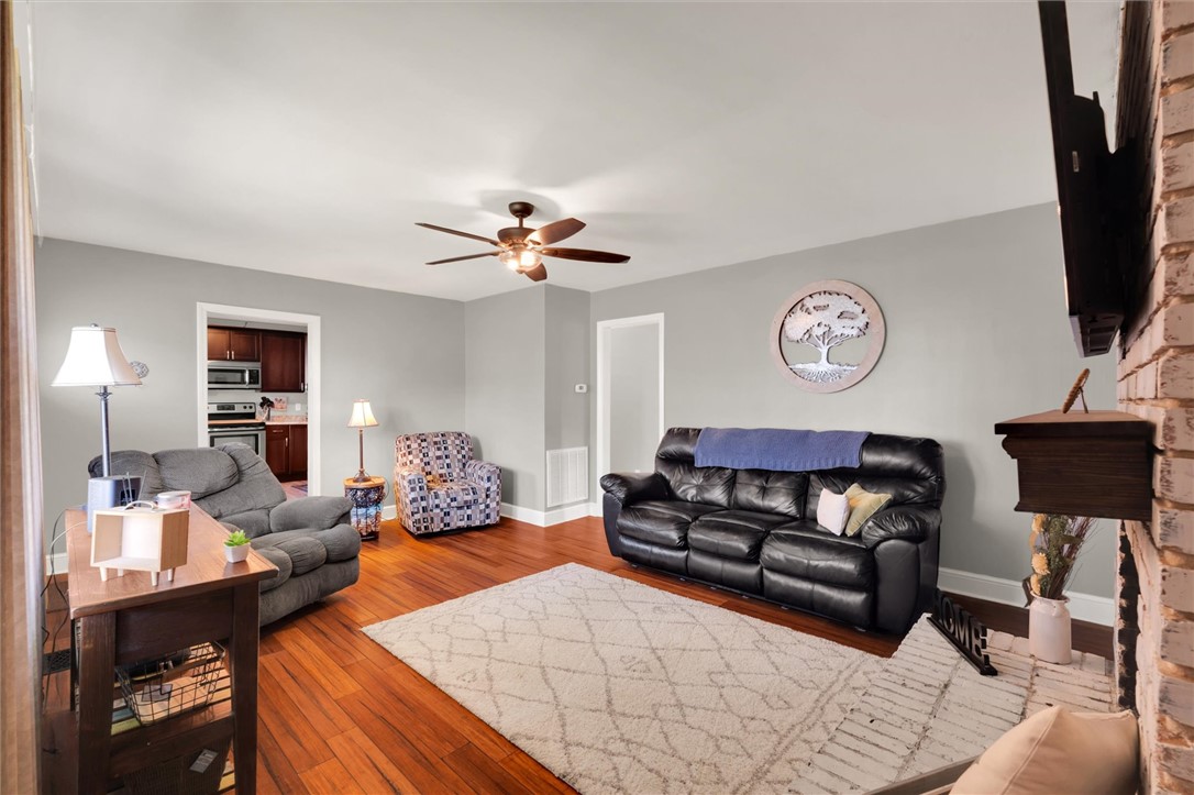 503 Stone Drive Anderson, SC 29625 - Photo 9 of 25 This living room features gleaming hardwood floors and a cozy fireplace, perfect for relaxation and gatherings.