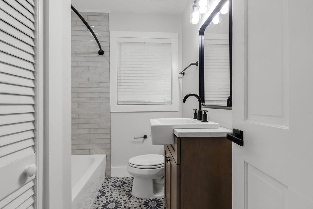 2219 Sharon Way Decatur, GA 30032 - Photo 13 of 23 a bathroom with a sink a toilet and shower