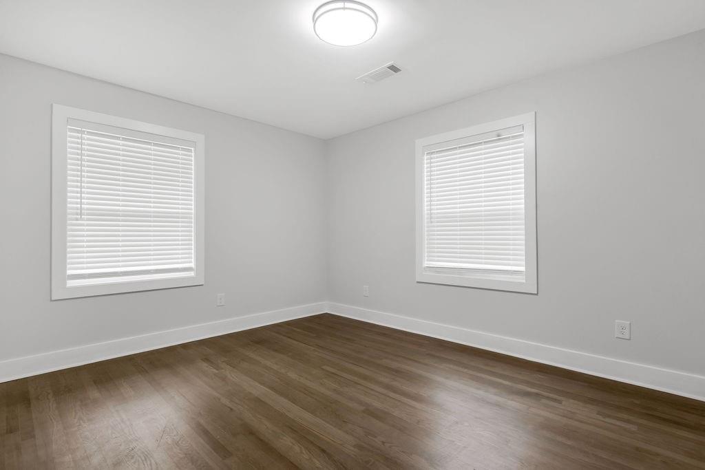 2219 Sharon Way Decatur, GA 30032 - Photo 16 of 23 a view of an empty room with wooden floor and a window