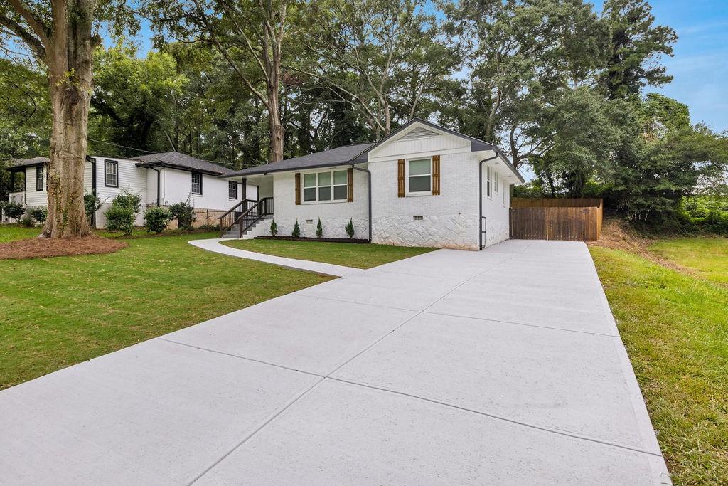 2219 Sharon Way Decatur, GA 30032 - Photo 23 of 23 a front view of a house with a yard and trees