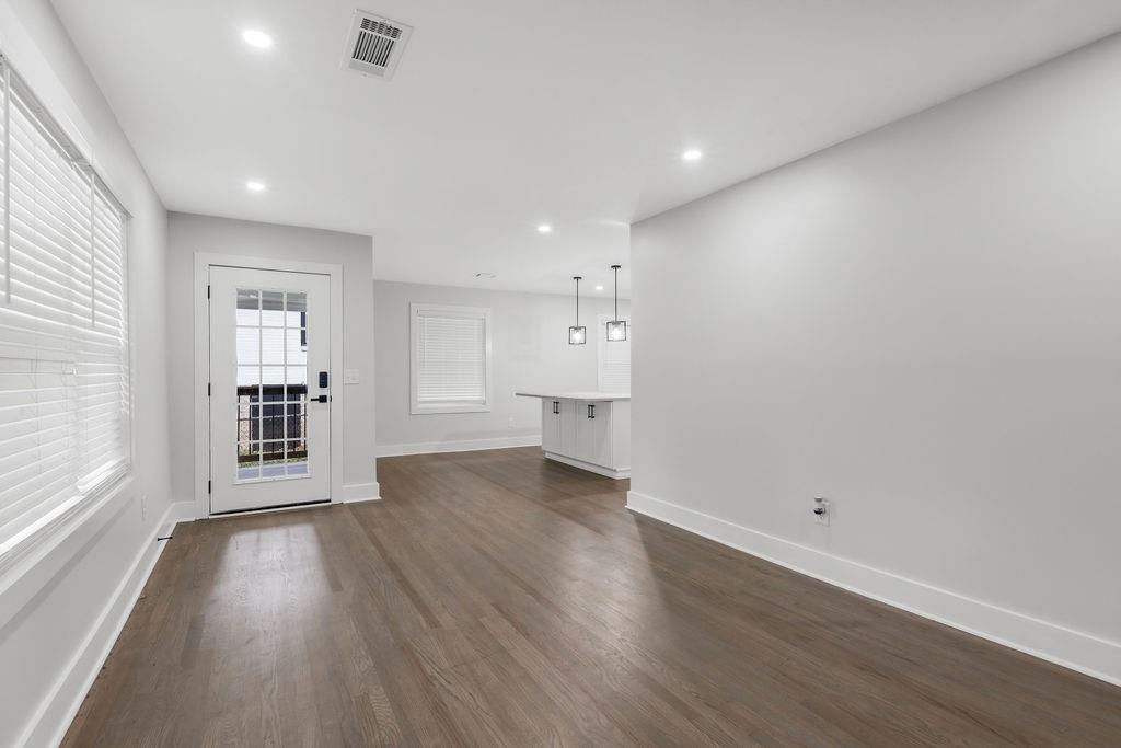 2219 Sharon Way Decatur, GA 30032 - Photo 4 of 23 an empty room with wooden floor and windows