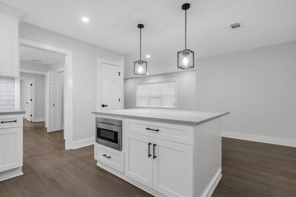 2219 Sharon Way Decatur, GA 30032 - Photo 7 of 23 a kitchen with white cabinets and window