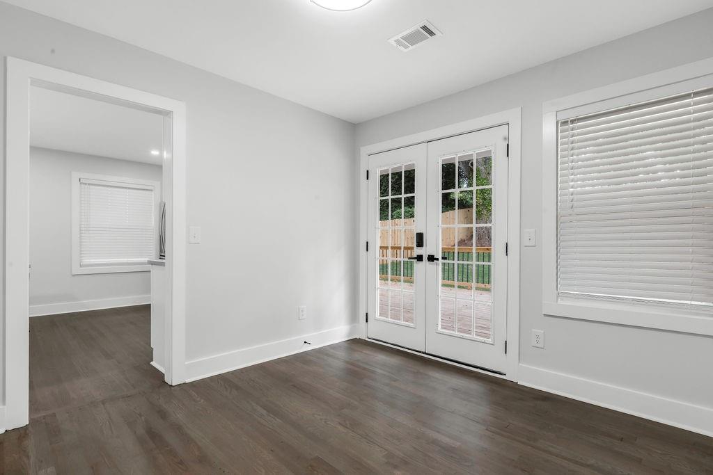 2219 Sharon Way Decatur, GA 30032 - Photo 8 of 23 an empty room with wooden floor and windows