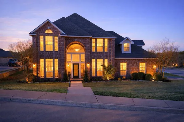 a front view of a house with a yard