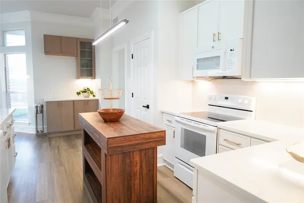 a kitchen with granite countertop a sink stove and cabinets
