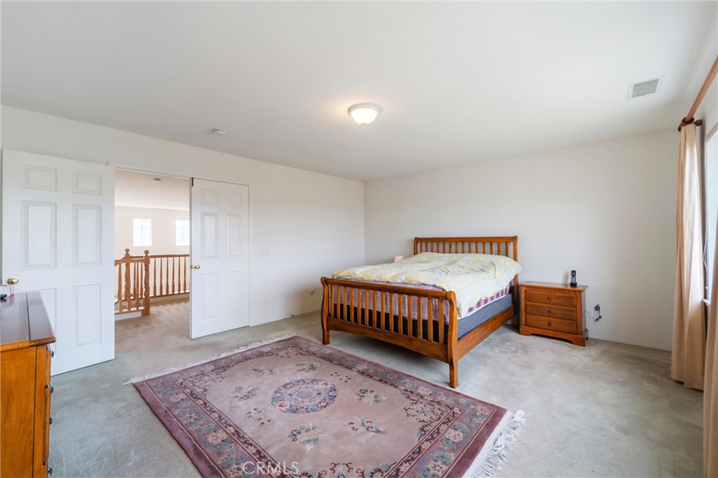 17191 Greentree Drive Riverside, CA 92503 - Photo 27 of 53 a bedroom with a bed and wooden floor