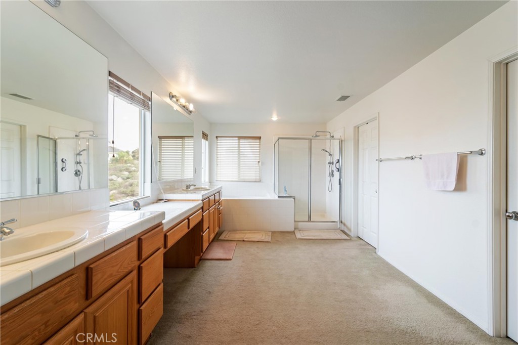 17191 Greentree Drive Riverside, CA 92503 - Photo 28 of 53 a large bathroom with a granite countertop tub sink shower and mirror