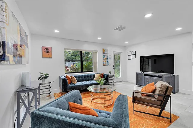 a living room with furniture and a flat screen tv