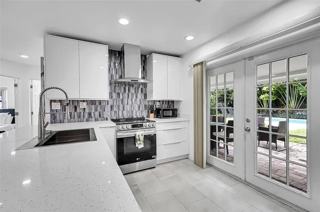 a kitchen with stainless steel appliances granite countertop a stove and a sink
