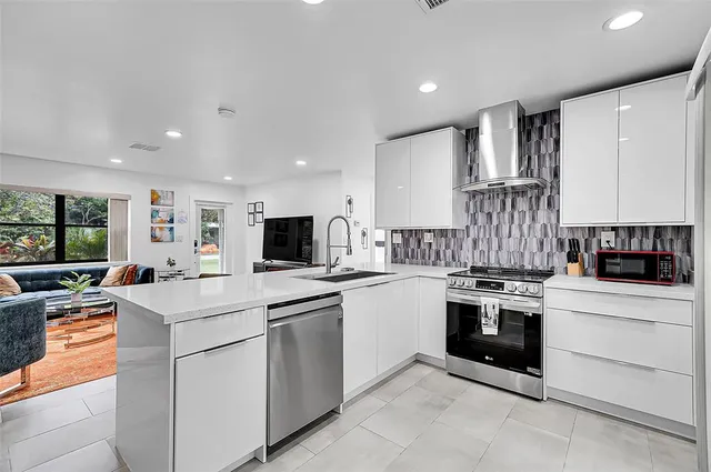 a kitchen with appliances a sink and cabinets