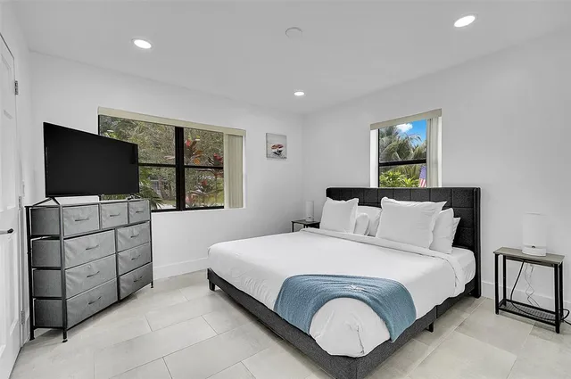 a bedroom with a bed and a flat screen tv