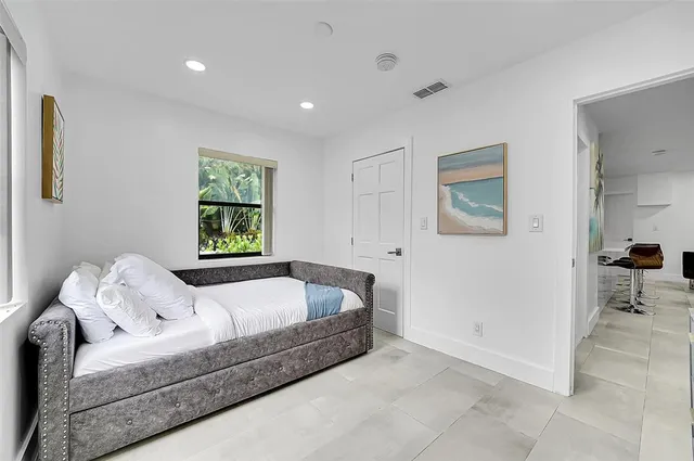 a bedroom with a bed and a couch