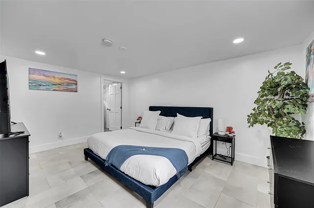 a bedroom with a bed and a television