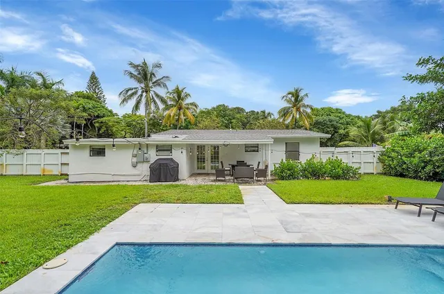 a view of a house with a yard and sitting area