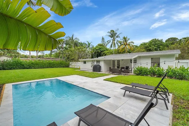 a view of swimming pool with a yard