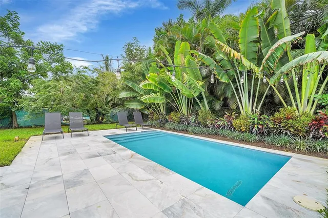 a view of backyard with sitting area