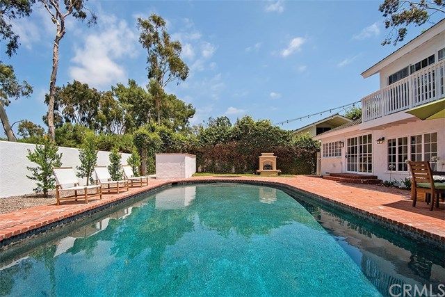 a view of a house with swimming pool and sitting area