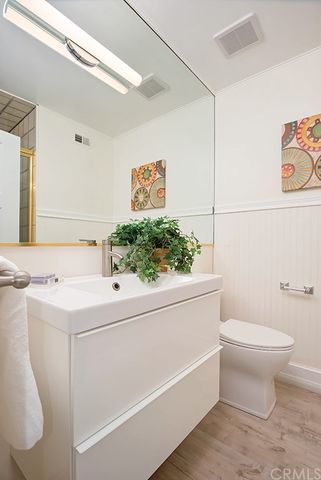 a bathroom with a sink a toilet and a shower