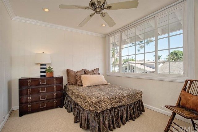 a bedroom with a bed dresser and a window