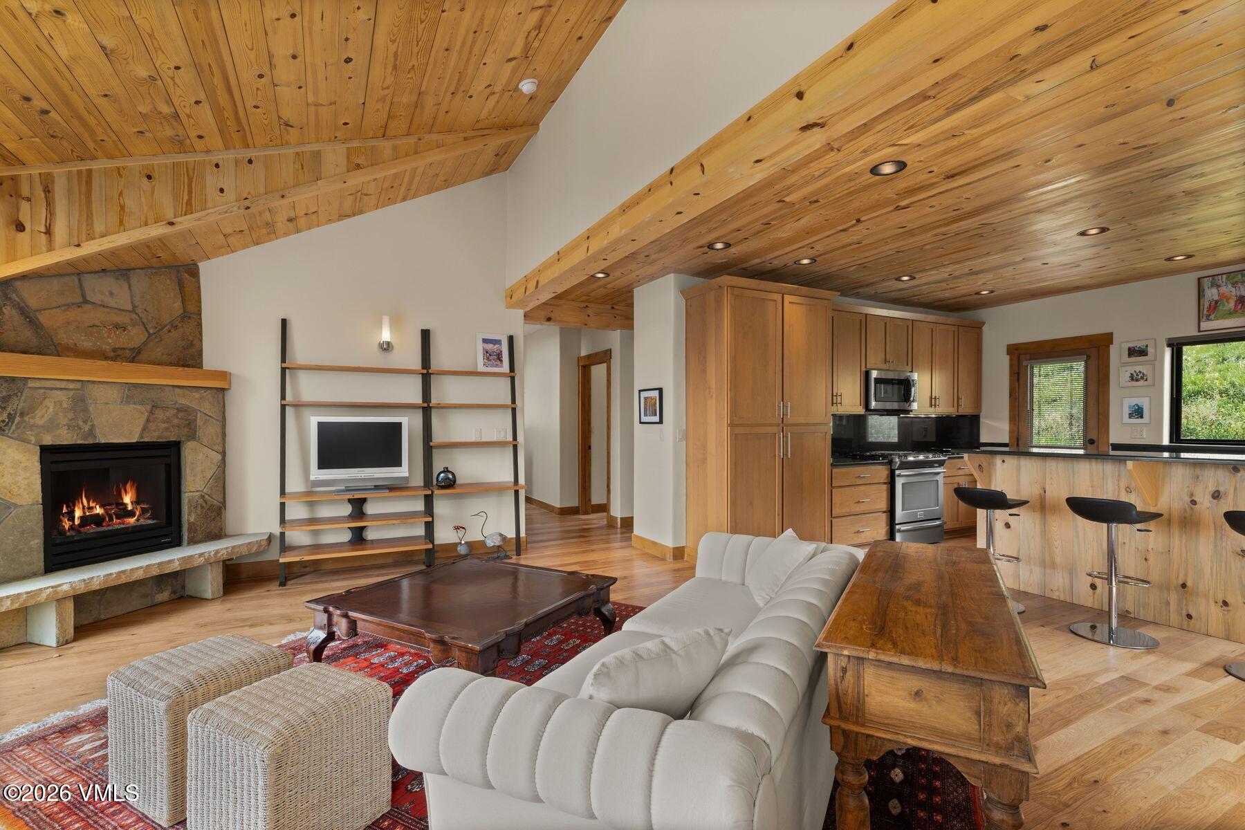 1015 West Wildwood Road, Unit F Avon, CO 81620 - Photo 7 of 35 a living room with furniture and a fireplace