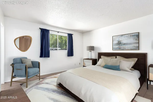 a bedroom with a large bed and a window