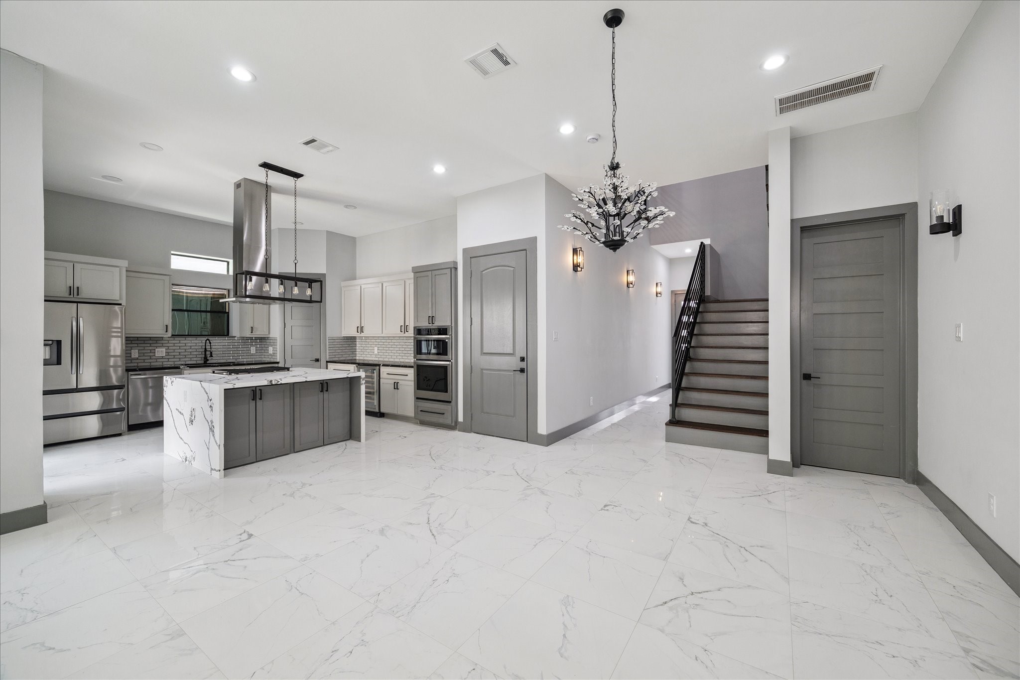 2319 Tuam Street Houston, TX 77004 - Photo 12 of 28 Tile floors extend through the open living area, drawing the eye toward the modern kitchen and upstairs retreat.