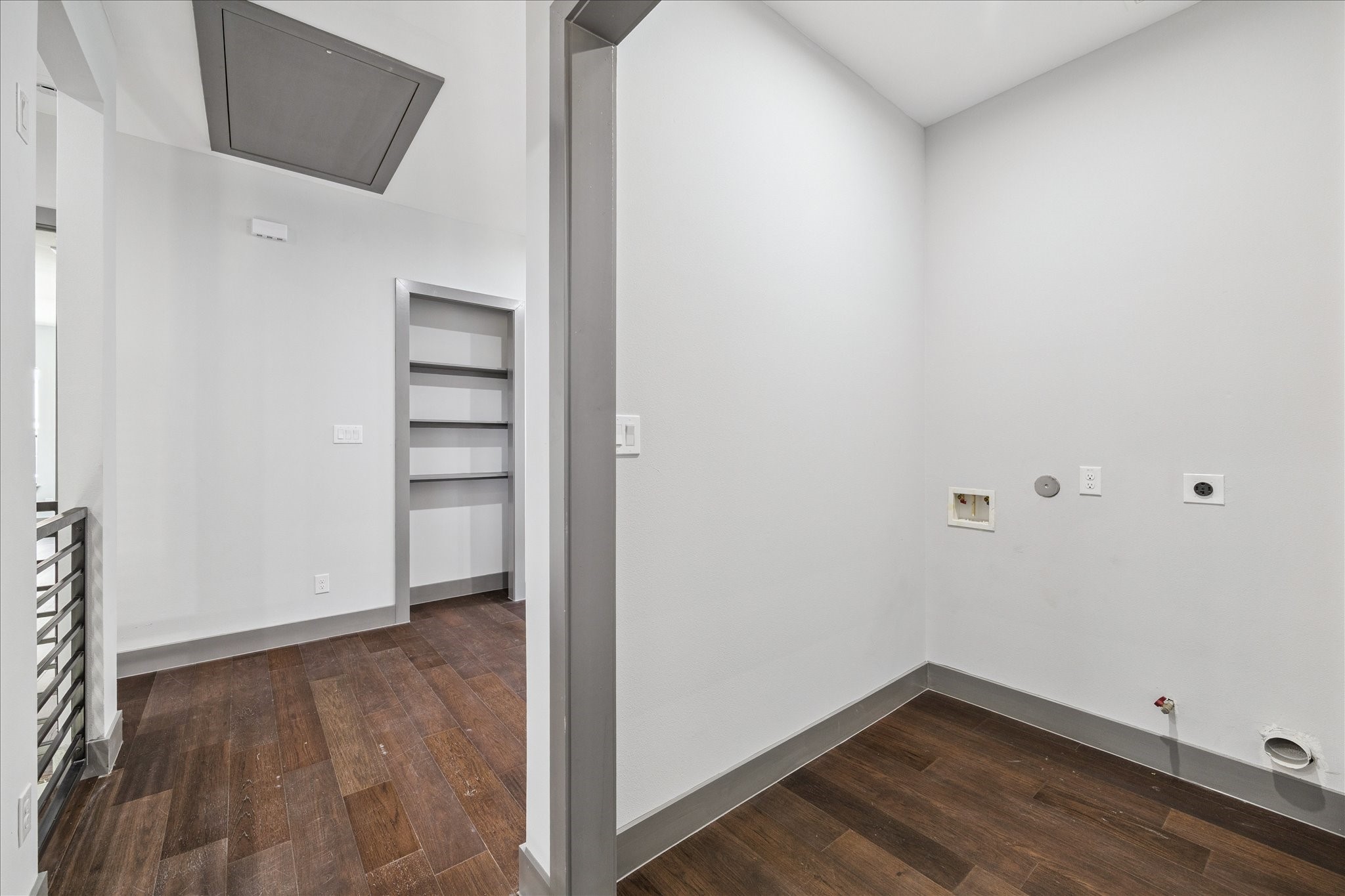 2319 Tuam Street Houston, TX 77004 - Photo 26 of 28 Washer and dryer connections with built-in shelving make the upstairs laundry area both functional and efficient, while its placement near the bedrooms simplifies household tasks.