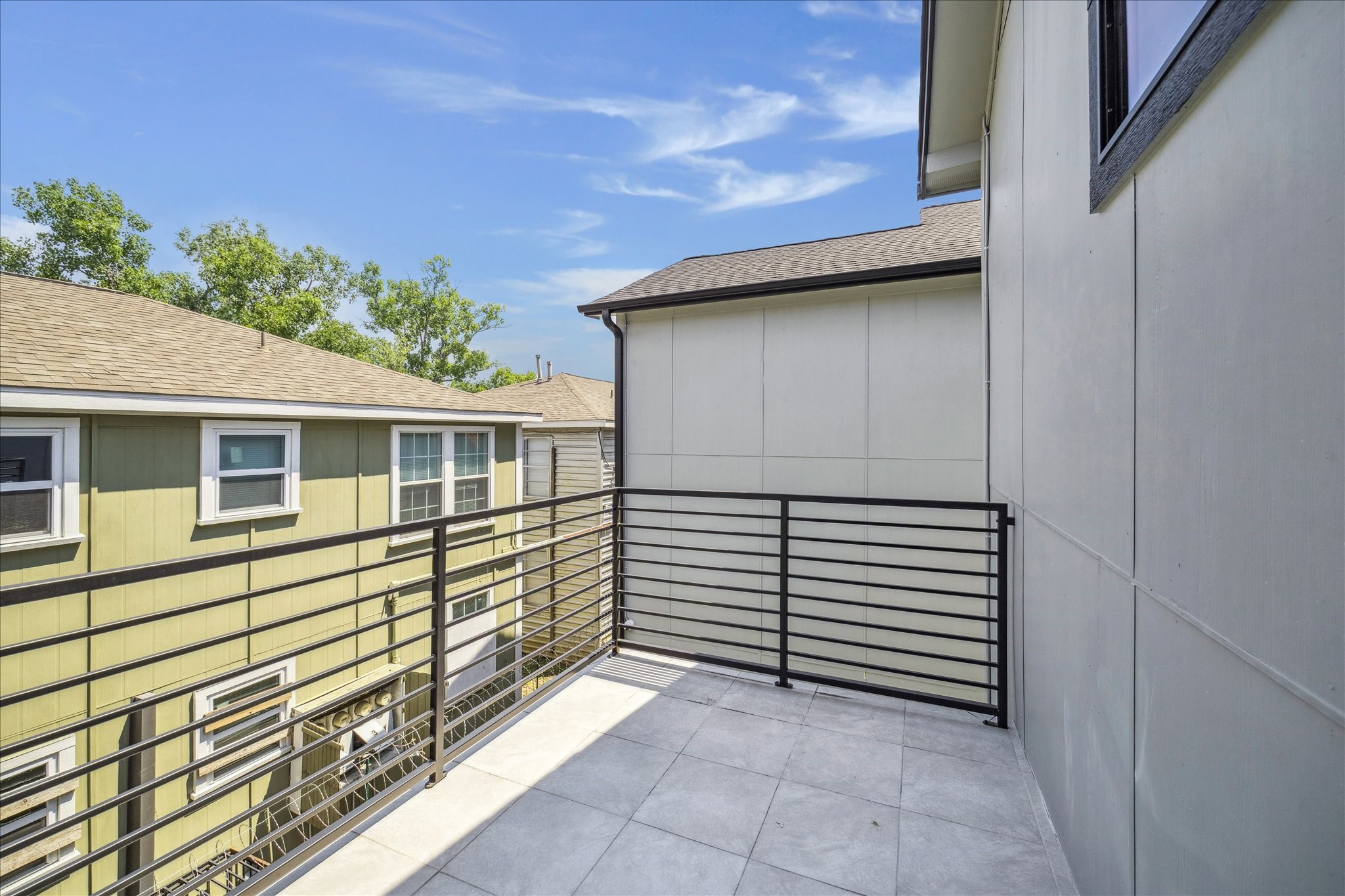 2319 Tuam Street Houston, TX 77004 - Photo 27 of 28 Primary bedroom opens onto this private balcony, providing fresh air and a quiet outdoor retreat. With space for seating, it’s an ideal spot to relax or enjoy a morning coffee.