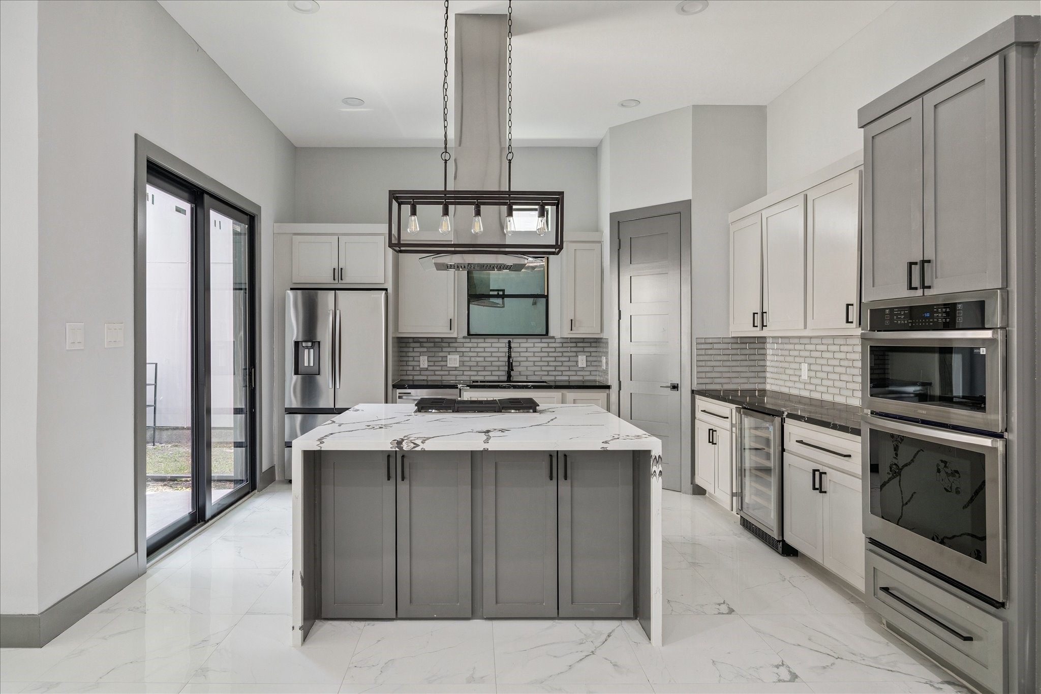 2319 Tuam Street Houston, TX 77004 - Photo 8 of 28 From this view, the island serves as the central hub, perfectly positioned for gathering while still leaving plenty of room for movement around the perimeter. The cabinetry and appliances line the back wall in an efficient arrangement, keeping everything within reach without interrupting the sightlines to the rest of the home