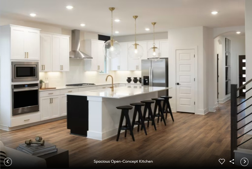 6408 Cypress Ranch Boulevard Spicewood, TX 78669 - Photo 6 of 13 a large kitchen with stainless steel appliances kitchen island granite countertop a stove a sink a refrigerator and a microwave