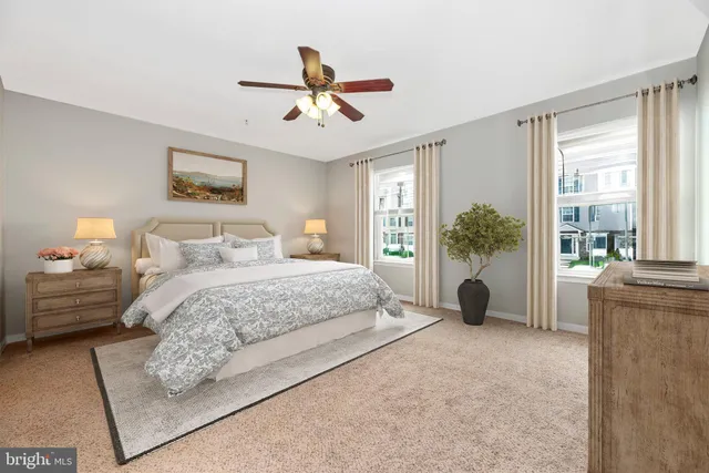 a spacious bedroom with a bed and a large window