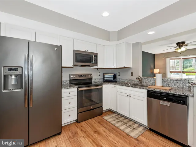 a kitchen with a sink stove and refrigerator