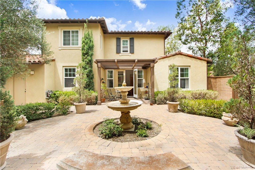 54 Clouds View Irvine, CA 92603 - Photo 6 of 39 a front view of a house with a yard and fountain