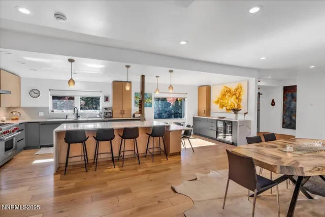 a living room with furniture a wooden floor and potted plant