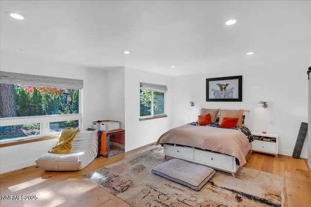 a bedroom with a bed and chair