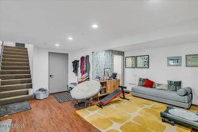 an aerial view of residential house with outdoor space and trees all around